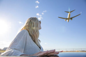 Woman Looking At Airplane