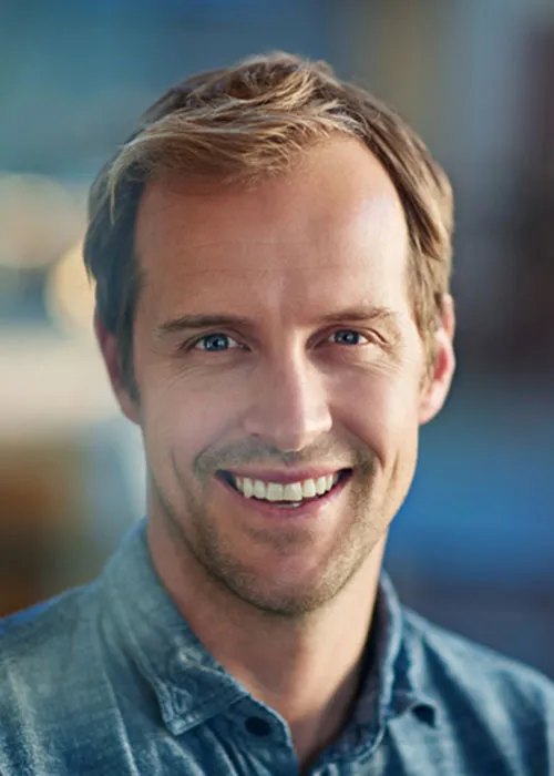 Defocused shot of a handsome young businessman in his workplace