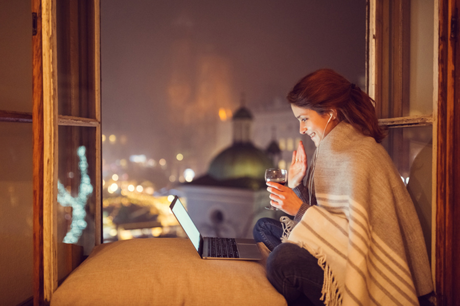 Smiling woman waving with hand on video call
